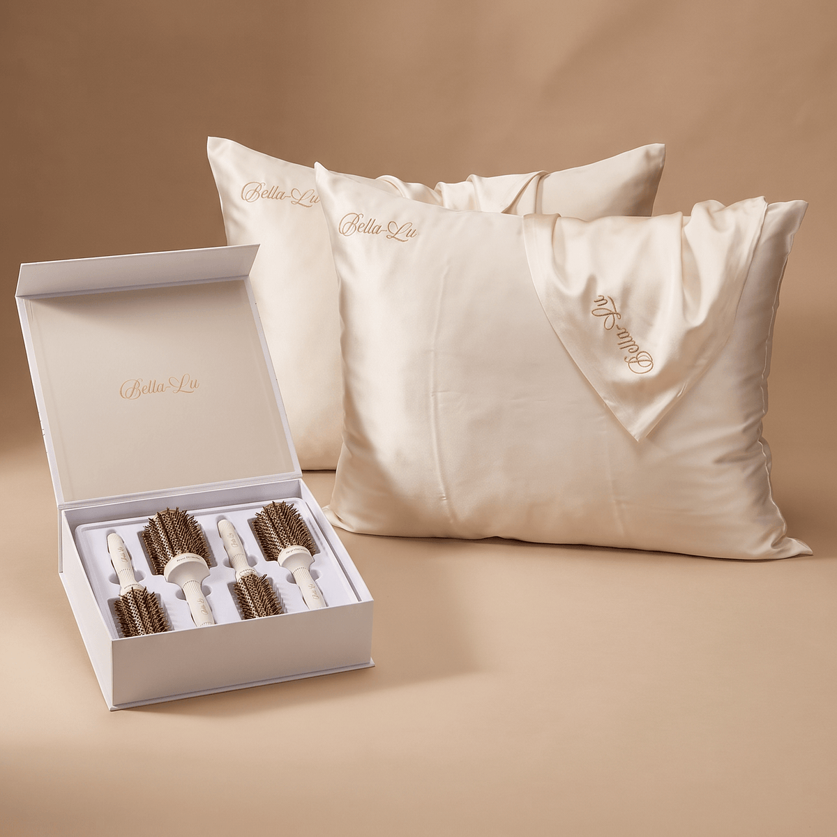 Two cream-colored silk pillowcases with gold embroidered &